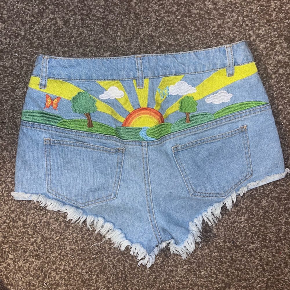 Dolls Kill Sunrise Embroidered Cheeky Cutoff Denim Shorts Jorts Sun Butterfly